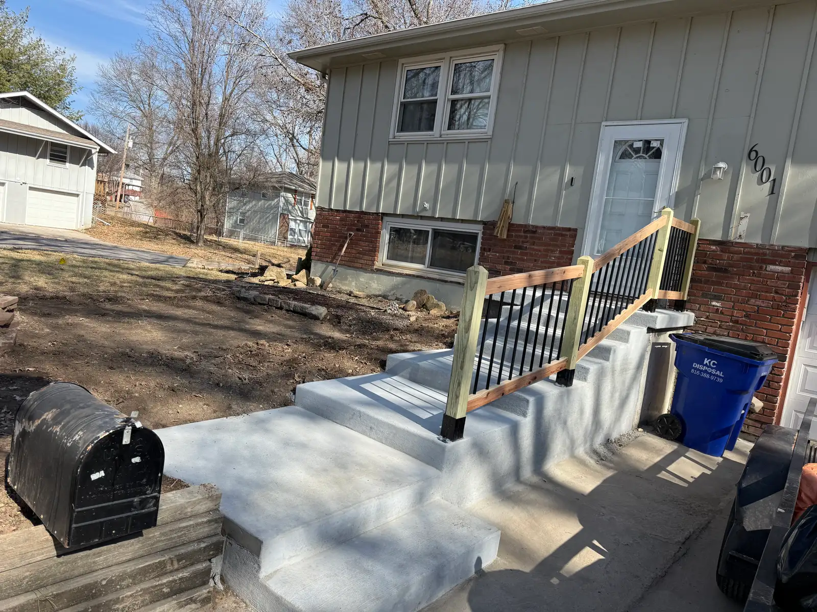 New concrete front steps Kansas City — with railing installation | Ford Concrete